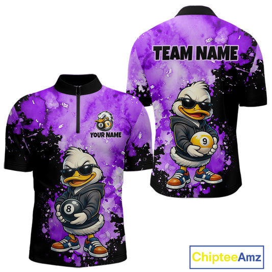 Front and back views of a short-sleeve polo shirt with a purple and black watercolor splatter design, featuring a cartoon duck character wearing sunglasses and holding pool balls. The front has a half-zip collar, a small cartoon logo, and the text 'YOUR NAME', while the back has 'TEAM NAME' printed at the top.