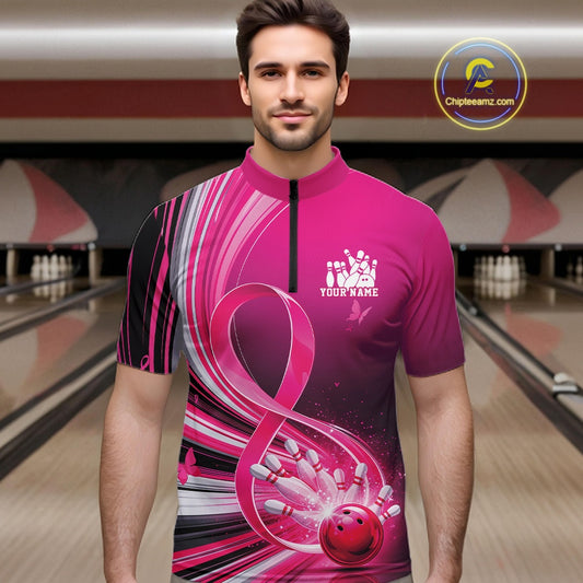 Male model wearing a pink bowling quarter zip with breast cancer awareness ribbons and bowling graphics, front view at the bowling lane