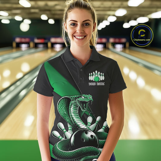 Female model in a bowling alley wearing a black bowling polo with green cobra artwork and bowling-themed accents.