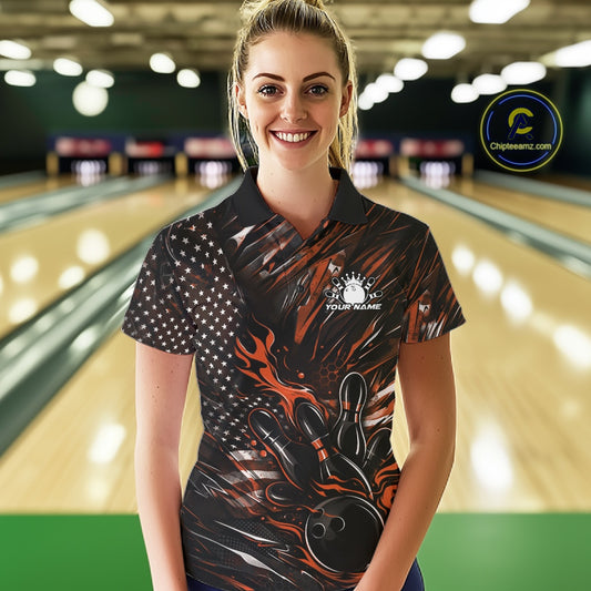 Female model wearing a black and orange bowling polo shirt at a bowling lane with fiery bowling strike graphics and American flag styling.