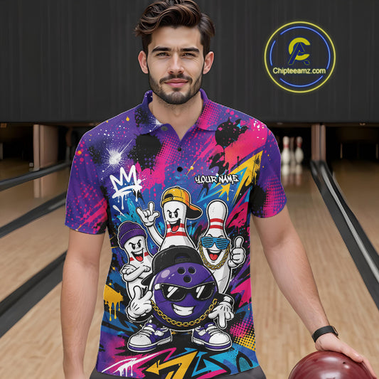 A man wearing a vibrant, colorful bowling graphic polo shirt stands in a bowling alley holding a bowling ball. The shirt features cartoon bowling pins, a bowling ball, and graffiti-style graphics in purple, pink, blue, and yellow.