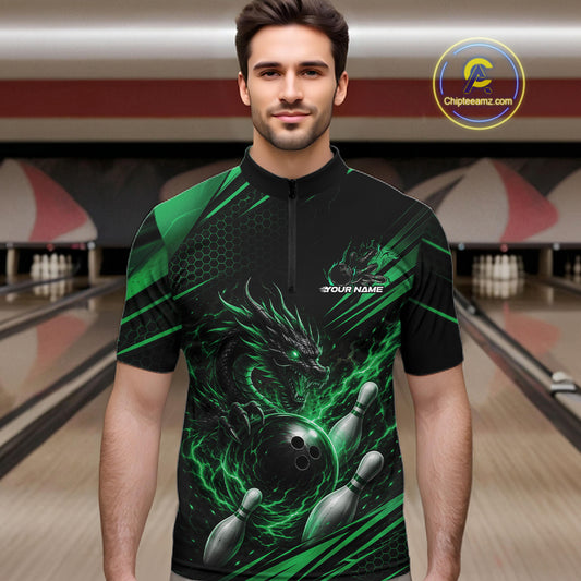 A man wearing a black and green bowling-themed quarter-zip bowling jersey with a dragon and bowling pins graphic, set against a bowling alley background.