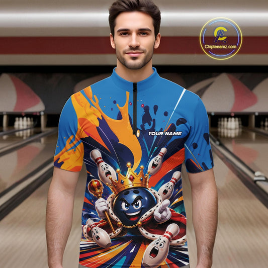 Front view of a male model wearing a bowling quarter zip shirt featuring a crowned cartoon bowling ball holding a royal scepter with cheering animated bowling pins and colorful paint splashes in a bowling lane.