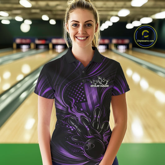 Female model at a bowling lane wearing a black and purple bowling polo shirt with patriotic bowling-themed graphics and fiery accents.