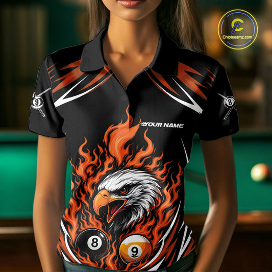 A woman wearing a black and orange custom polo shirt featuring a flaming eagle surrounded by billiard 8 and 9 balls.