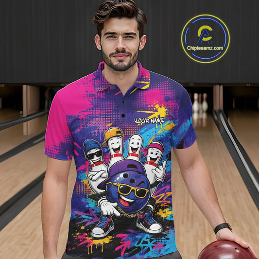 A man in a bowling alley wearing a vibrant, multicolor short-sleeve polo shirt with a cartoon bowling ball and pins graphic, holding a bowling ball. The shirt features a colorful graffiti-style pattern with pink, blue, purple, and yellow tones, and the text 'YOUR NAME' on the chest.
