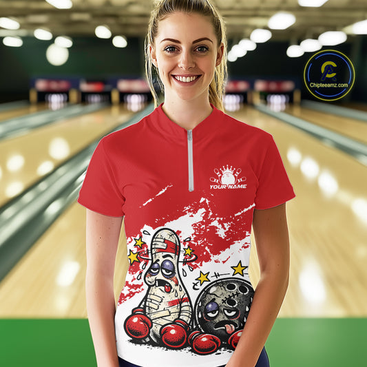 Female model in a bowling lane wearing a red and white quarter-zip shirt, playful boxing bowling ball and pin illustration with bold tones.