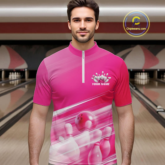 Male model front view in a bowling lane wearing a pink bowling quarter zip shirt with bowling ball and pins geometric artwork.