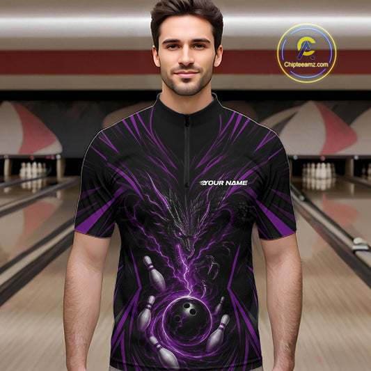 A man wearing a black short-sleeve zip-up bowling jersey with a purple and black dragon and bowling graphics, standing in a bowling alley.