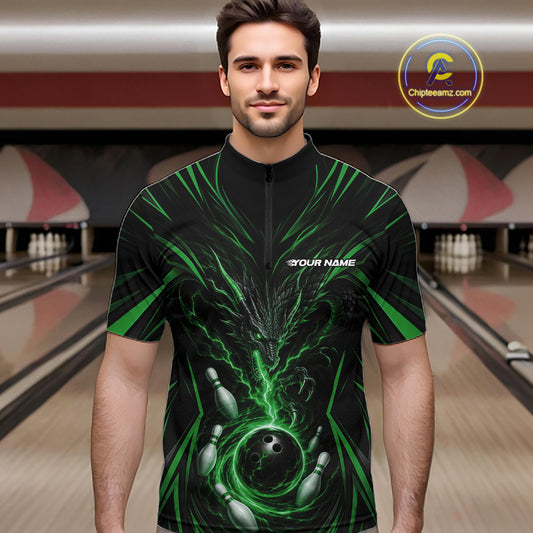 A man wearing a black short-sleeve zip-front jersey with a green and gray bowling-themed graphic print, standing in a bowling alley. The jersey has a white 'TEAM NAME' placeholder on the chest