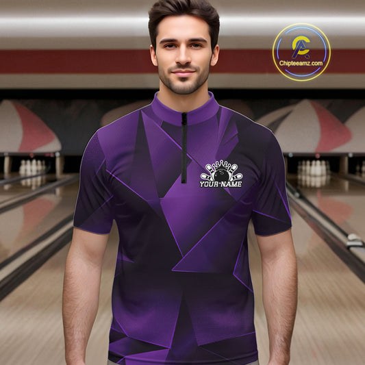 Man wearing a purple bowling shirt with a logo in a bowling alley.