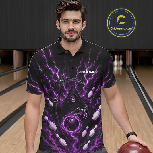 A man wearing a black short-sleeve polo shirt with a purple Grim Reaper and lightning graphic, standing in a bowling alley holding a bowling ball.