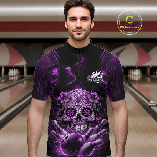 Male model at a bowling lane wearing a black and purple quarter-zip bowling shirt with a floral sugar skull, bowling ball, and bowling pins artwork.