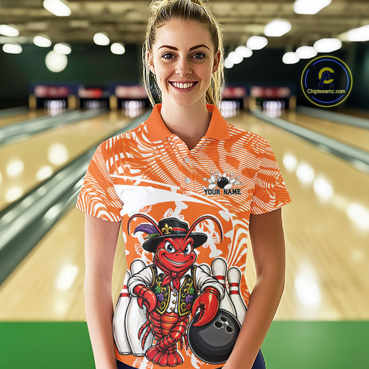Front view of a female model in a bowling alley wearing an orange custom bowling polo shirt with a funny Cajun crawfish leaning on a bowling ball and a swamp inspired texture background.