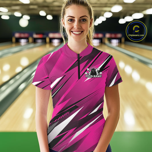 Woman wearing a pink bowling shirt with a logo in a bowling alley