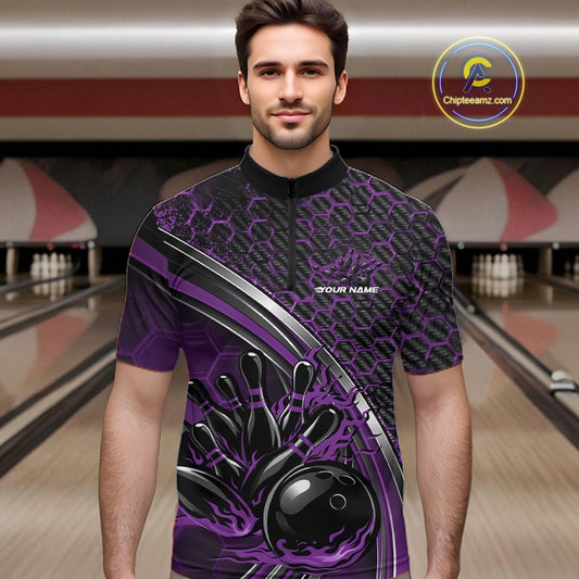 Male model in a bowling lane wearing a black and purple quarter zip shirt with honeycomb accents and a fiery bowling strike illustration.