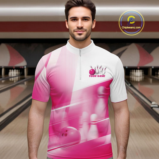 Male model front view at the bowling lane wearing a white and pink bowling quarter zip shirt with bowling ball and pins pattern.