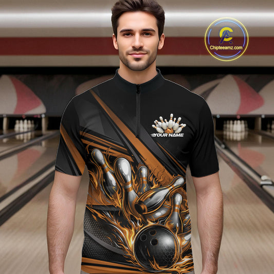 Male model in a bowling lane wearing a black quarter-zip shirt, gold flame bowling ball hitting pins with modern geometric stripe design.