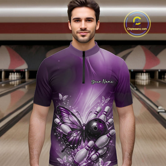 Male model wearing a purple bowling quarter-zip shirt at a bowling lane with butterfly artwork, bowling ball graphics, and scattered pins.