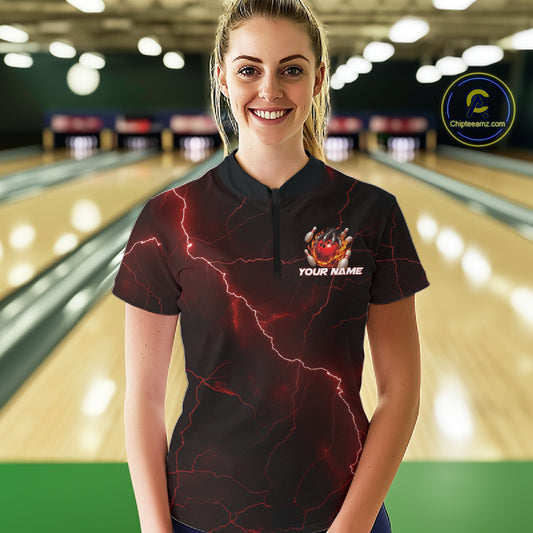 Female model wearing a black and red quarter-zip with dragon claw bowling artwork and scattered pins.