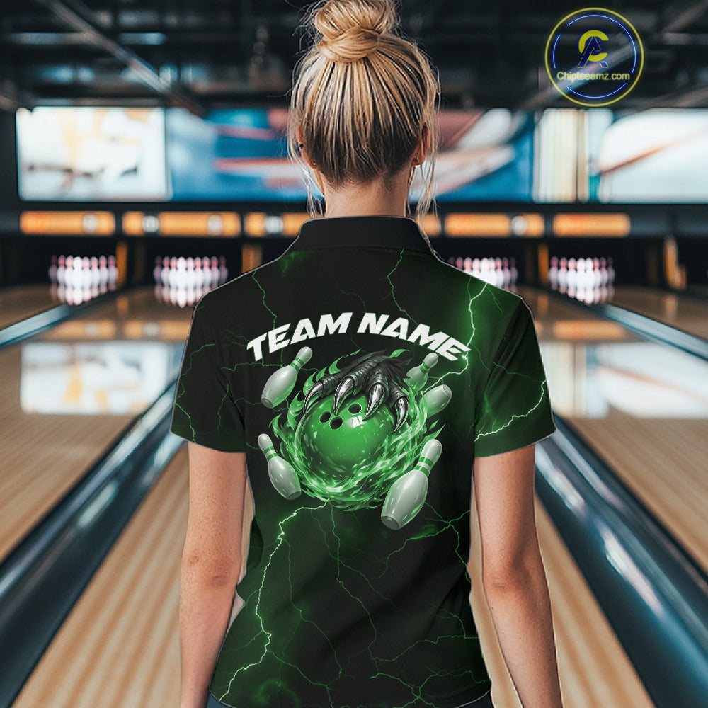 Back view of a black and green womens quarter-zip showcasing a flaming bowling ball and dragon claw motif.