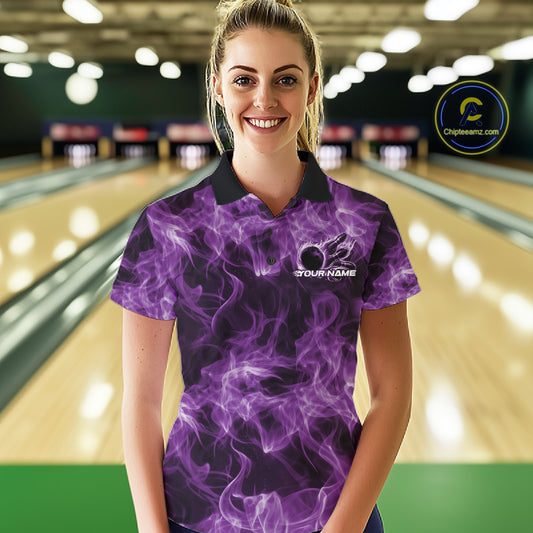 Female model wearing a purple bowling polo in a bowling lane with a bowling ball encircled by flames.