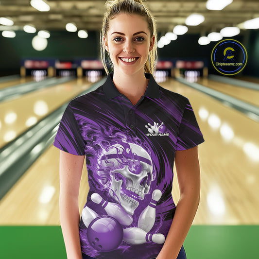 Person wearing a purple bowling shirt with a skull and bowling ball design in a bowling alley.