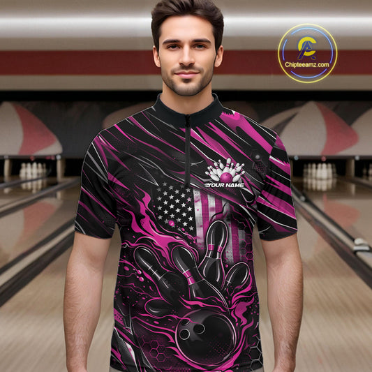 Male model wearing a black and pink bowling quarter-zip shirt at a bowling lane with fiery bowling strike artwork and patriotic graphics.