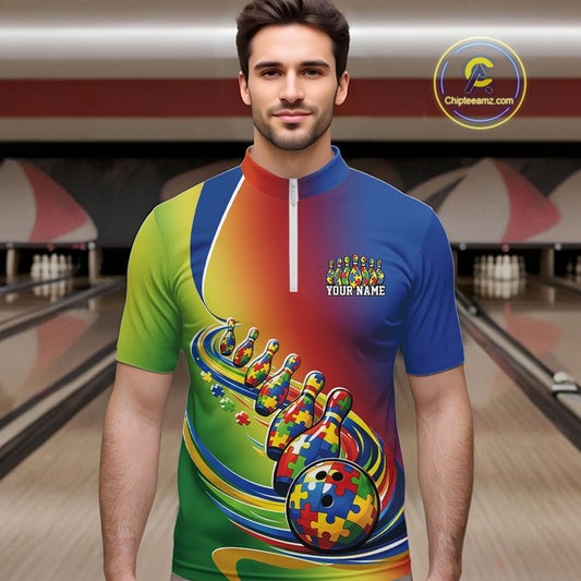 Male model in a bowling lane wearing a colorful quarter-zip shirt, autism puzzle bowling ball and pins illustration with vibrant symbolic artwork.