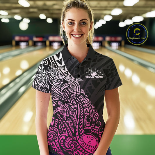 Female model wearing a black and pink bowling polo shirt at the bowling lane with tribal-inspired bowling artwork.