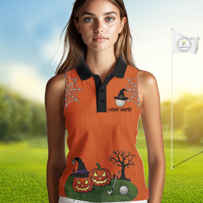 A woman modeling a sleeveless orange polo shirt with a black collar, featuring Halloween-themed graphics including spiderwebs, pumpkins, a witch hat, a bare tree, and a golf ball on a green grassy background with a blurred flagpole.