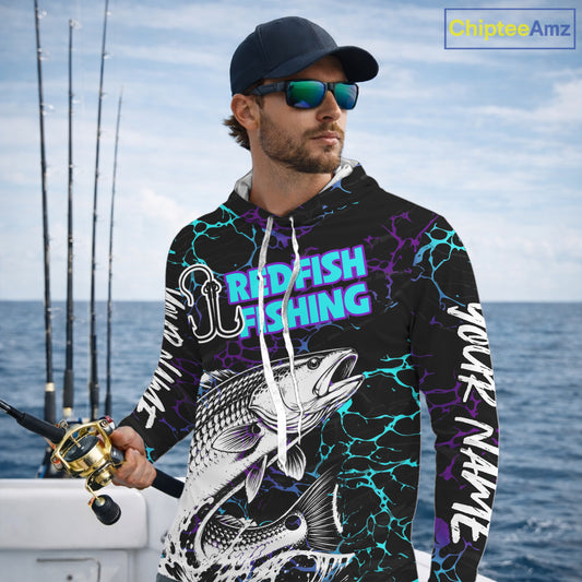 Angler wearing Redfish Fishing neon blue long sleeve hooded saltwater fishing shirt on the boat