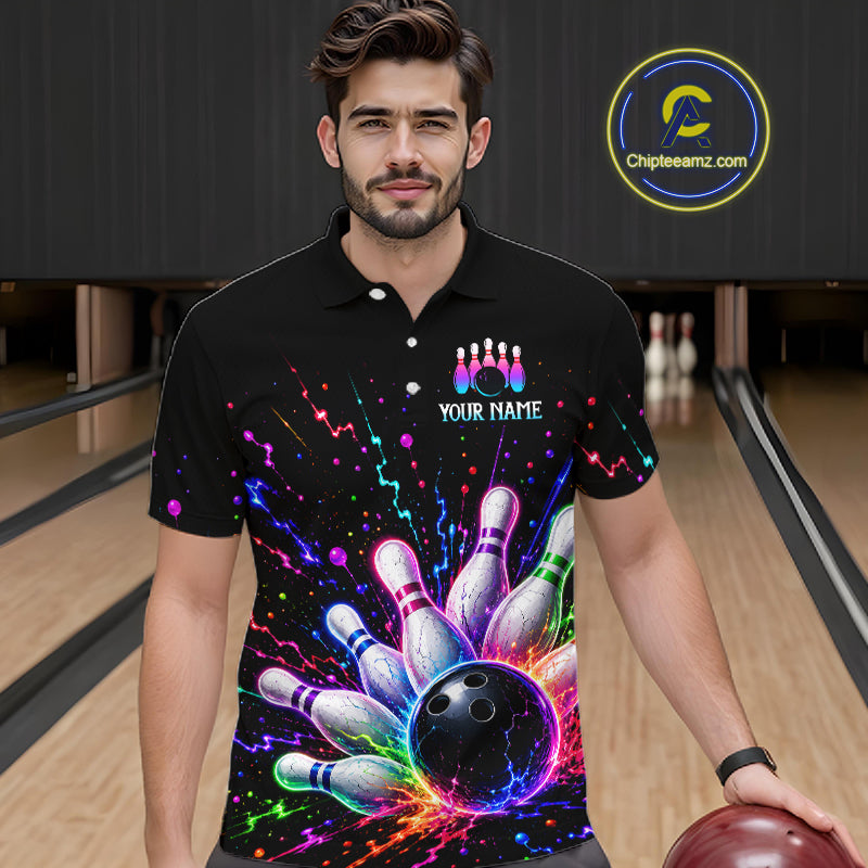 Man wearing a black bowling-themed shirt with colorful design in a bowling alley.