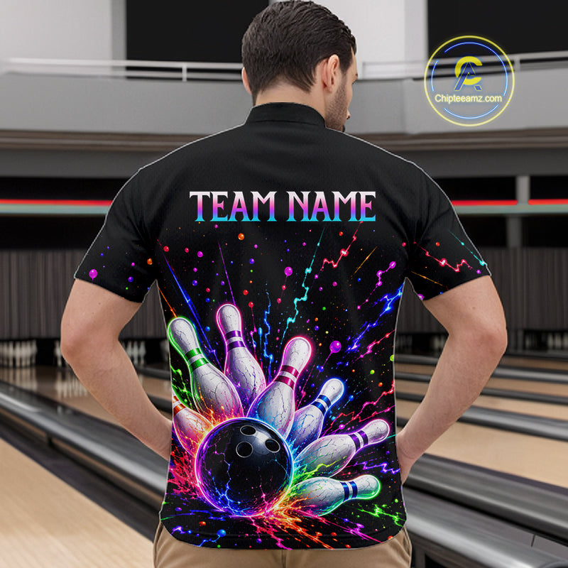 Person wearing a black bowling shirt with colorful design and 'TEAM NAME' text in a bowling alley.