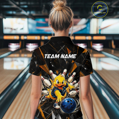 Female model wearing a custom black duck bowling quarter-zip shirt back view displaying the personalized team name above a playful cartoon graphic at the bowling alley
