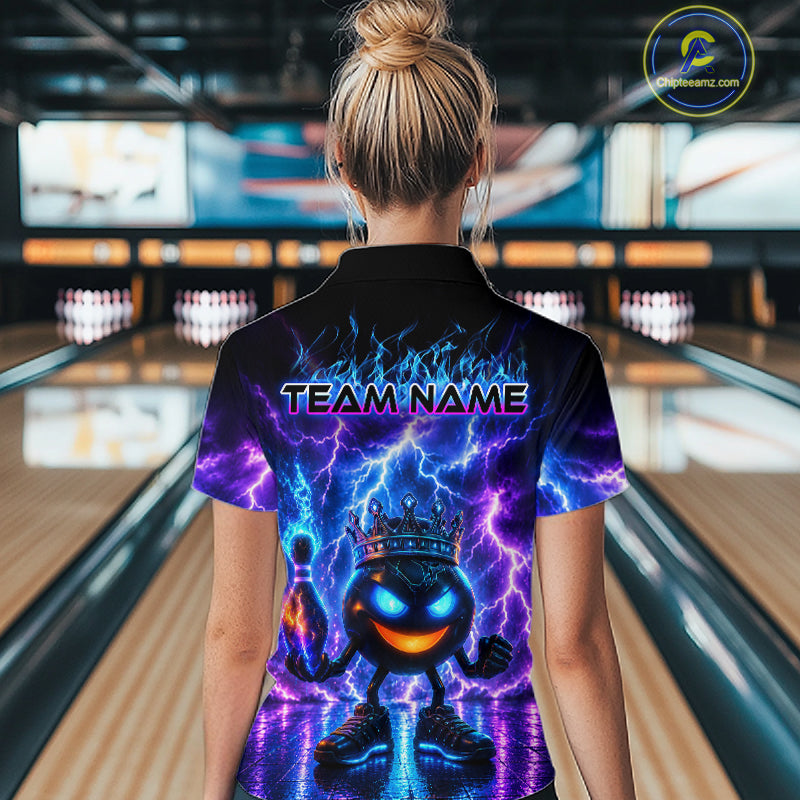 Person wearing a colorful bowling shirt with a team name design in a bowling alley.