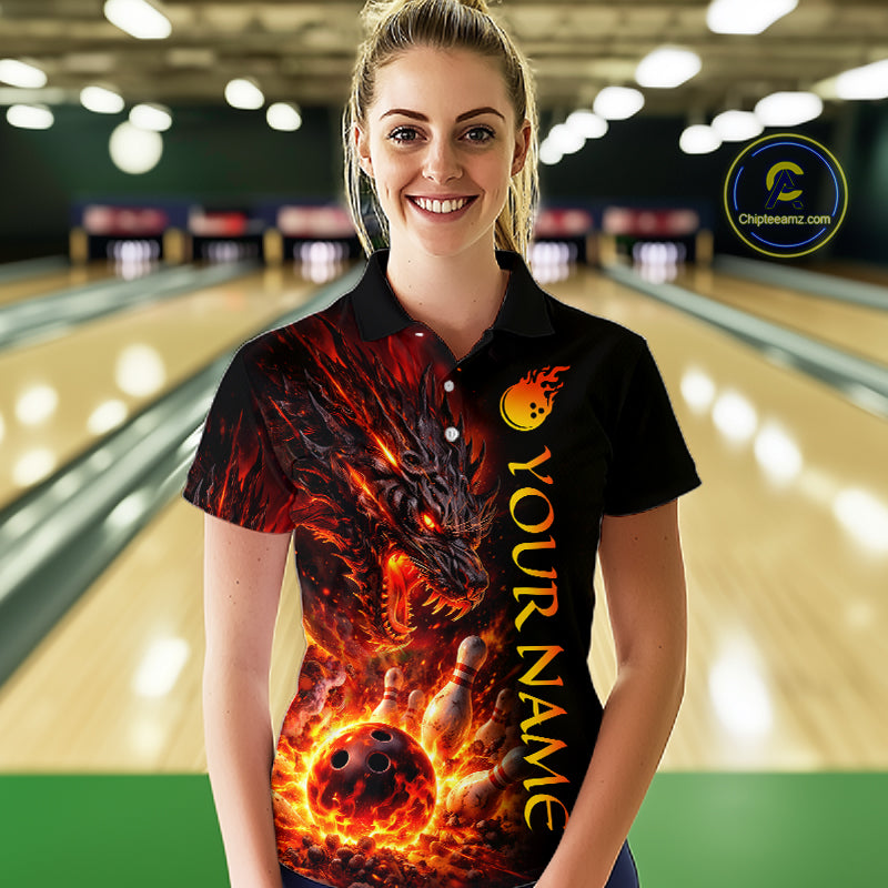 Woman wearing a bowling shirt with a dragon design in a bowling alley.
