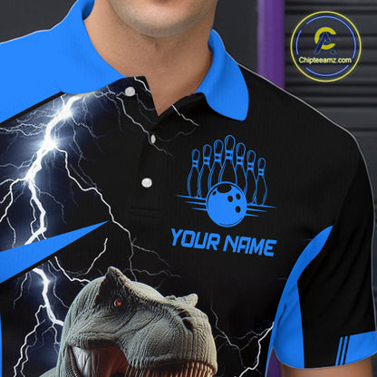 A close-up of a custom black and blue polo shirt featuring a lightning bolt design, a bowling pin and ball graphic with the text 'YOUR NAME', and a dinosaur graphic at the bottom. 