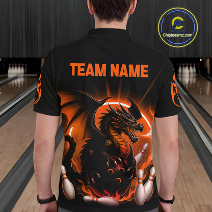 A person viewed from behind wearing a black short-sleeve bowling shirt with a large fiery dragon graphic and orange 'TEAM NAME' text on the back. Bowling lanes are visible in the background