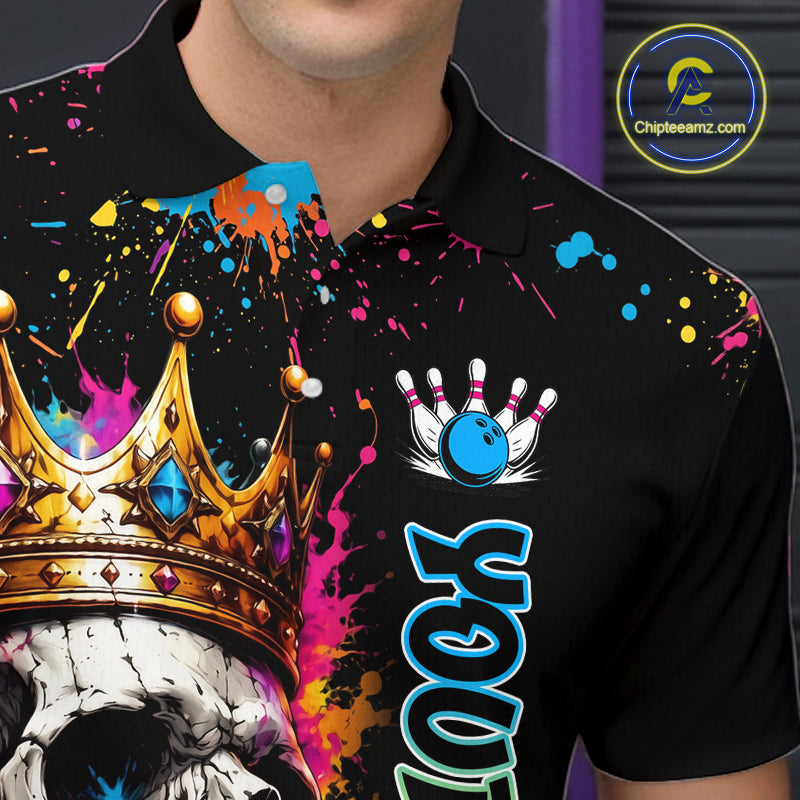 Black polo shirt with colorful designs and text, featuring a crown, skull, and bowling elements.
