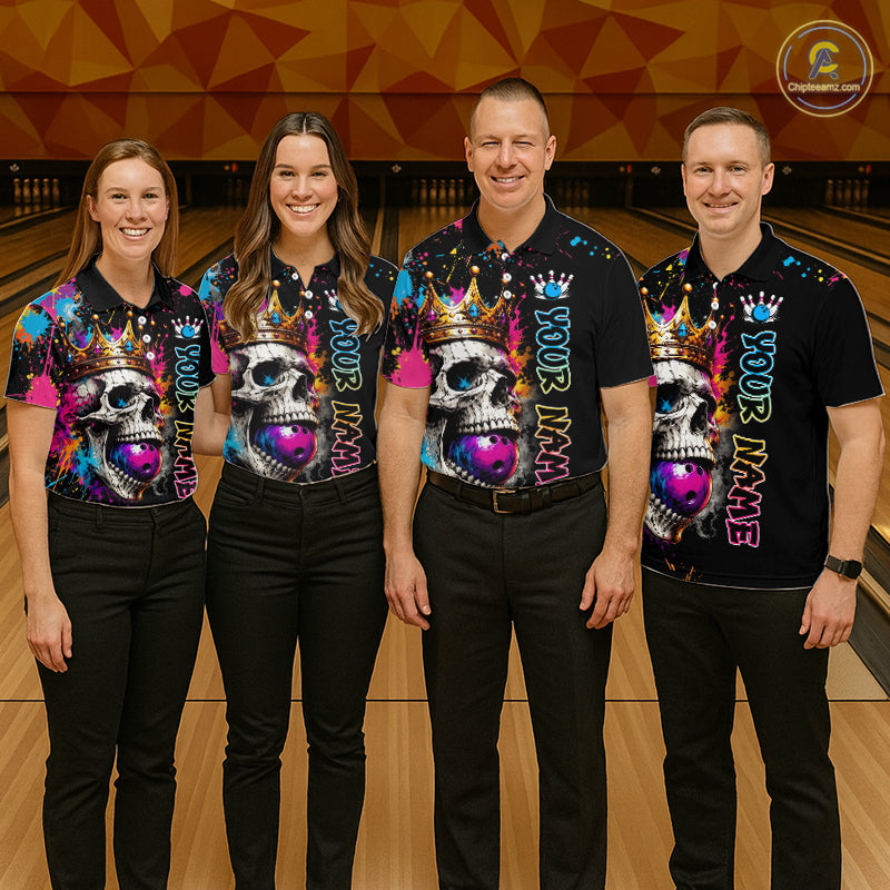 Four people wearing matching colorful shirts with skull designs on a bowling alley.