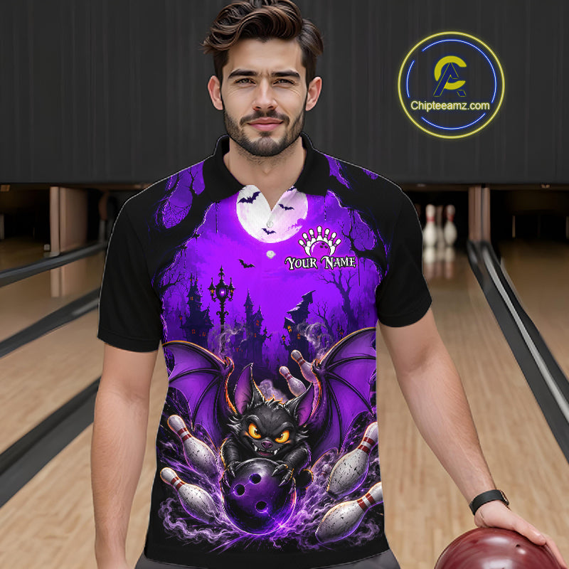 A man wearing a black short-sleeve polo shirt with a vibrant purple and black graphic print of a dragon, bowling pins, bats, and a full moon, standing in a bowling alley. 