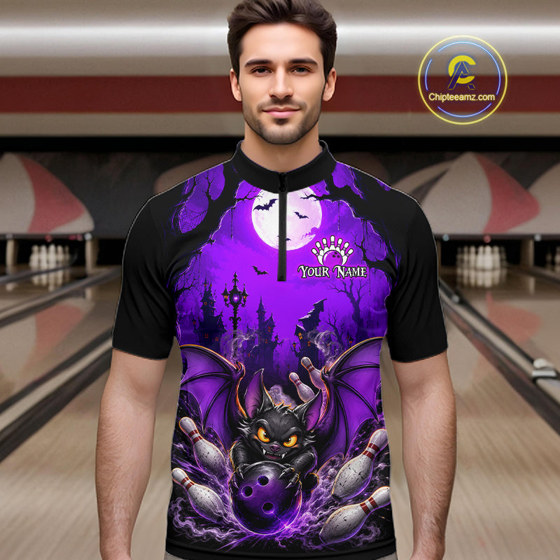A man wearing a black short-sleeve bowling jersey with a vibrant purple and black Halloween-themed graphic print featuring a bat, and bowling pins. The jersey has a mock neck and a mock zip collar, with 'Your Name' printed on the chest.