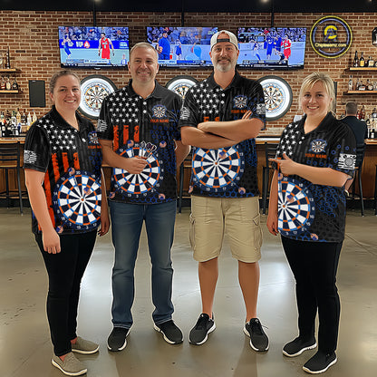 Group of four people in a sports bar wearing matching custom black darts team polo shirts featuring an American flag and dartboard design.