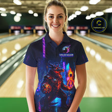 Load image into Gallery viewer, Woman wearing custom navy alligator bowling polo shirt front view featuring a glowing bowling ball and neon blue purple artwork, displaying Your Name, at the bowling alley