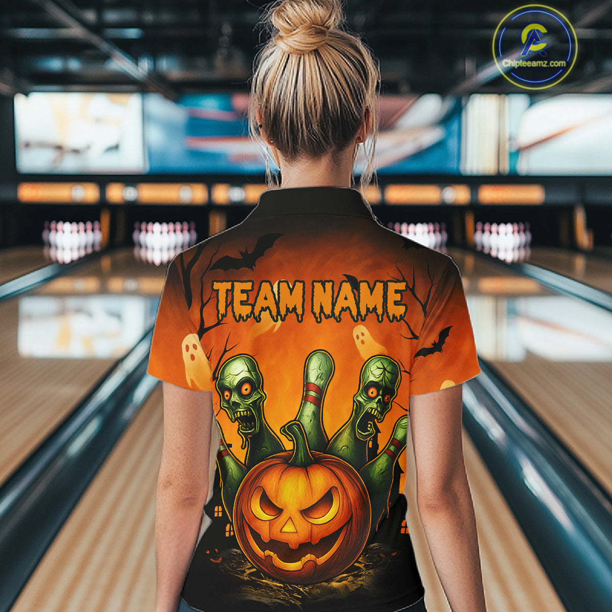 Person wearing a Halloween-themed shirt with 'TEAM NAME' text in a bowling alley.
