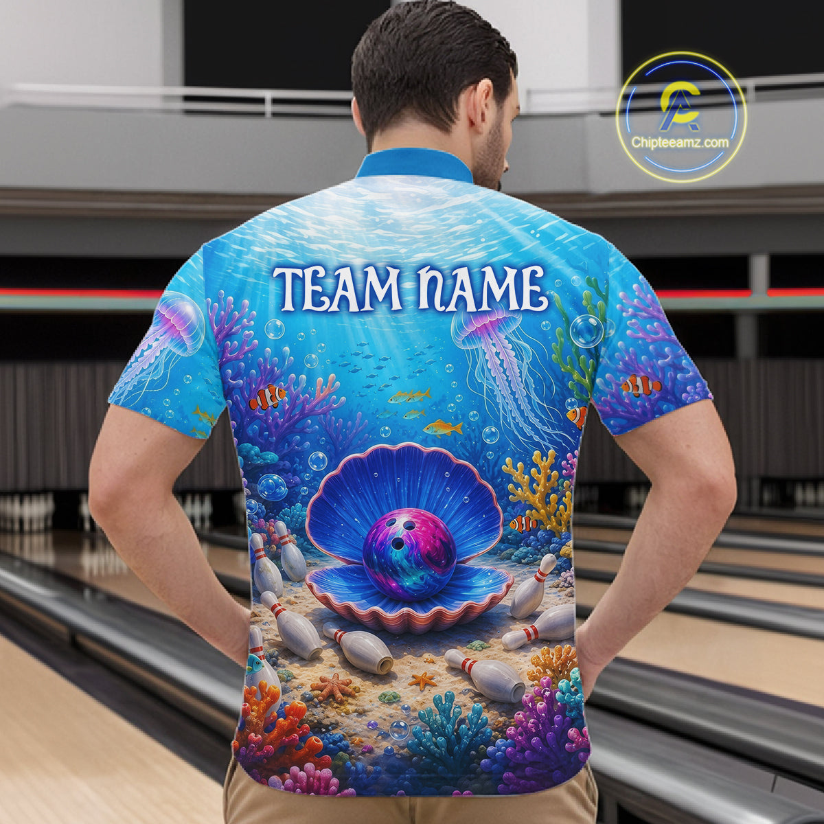 Man wearing a colorful bowling shirt with an underwater scene design in a bowling alley.