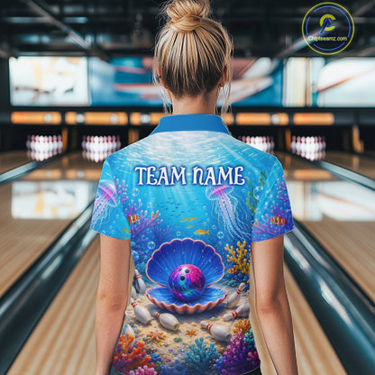Person wearing a colorful bowling shirt with an ocean-themed design in a bowling alley.