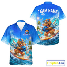 Load image into Gallery viewer, Blue shirt with bear surfing design on a white background, featuring 'Chiptee Amz' branding.