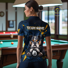 Load image into Gallery viewer, A back view of a custom black billiards polo shirt worn by a female model. The shirt features a bulldog on the back, with a large white 'TEAM NAME' text placeholder. The background is a billiards room with a table and hanging lights.